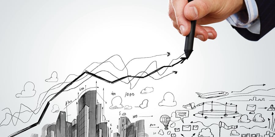 Close up of businessman hand drawing sketches of buildings