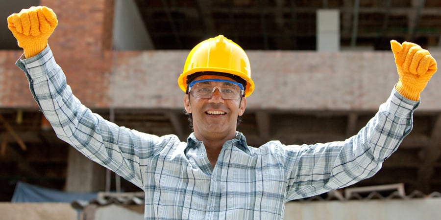 successful_enginee_smiling_with_arms_up_at_construction_site