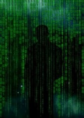 man standing veiled by binary codes in green and black