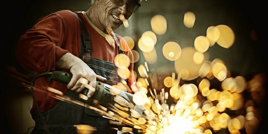 Industrial worker cutting and welding metal with many sharp sparks-1