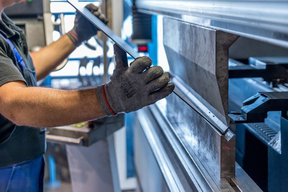 Factory worker bending tube