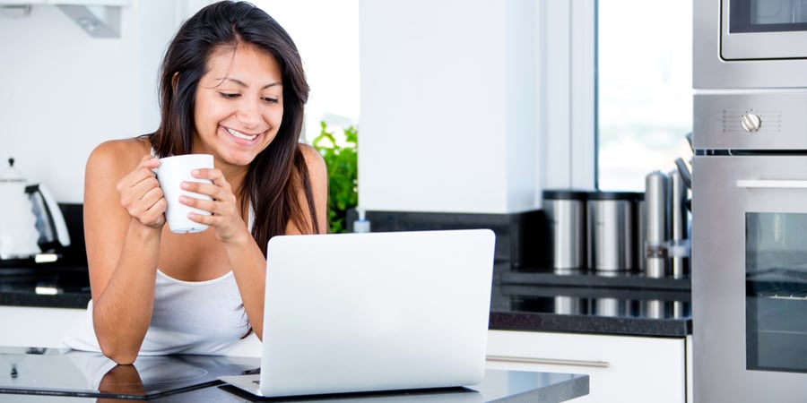 work from home woman with laptop in kitchen