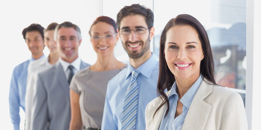 Smiling employees in a line at work