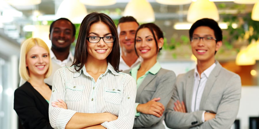 Smiling group of co-workers standing in office-1