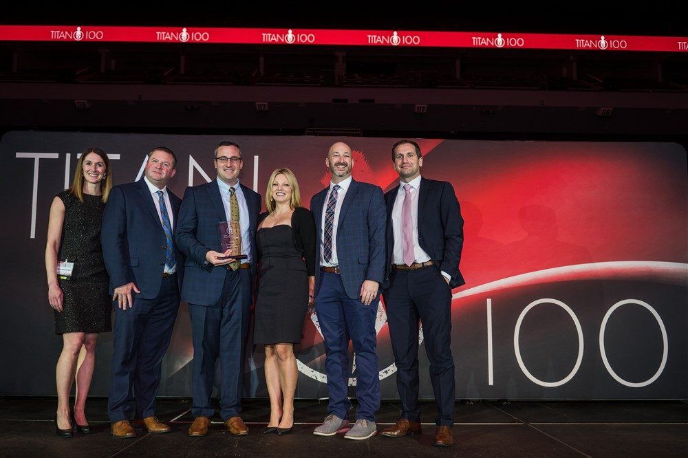 McClone team with Dustin recieving his 2025 Titan 100 Award