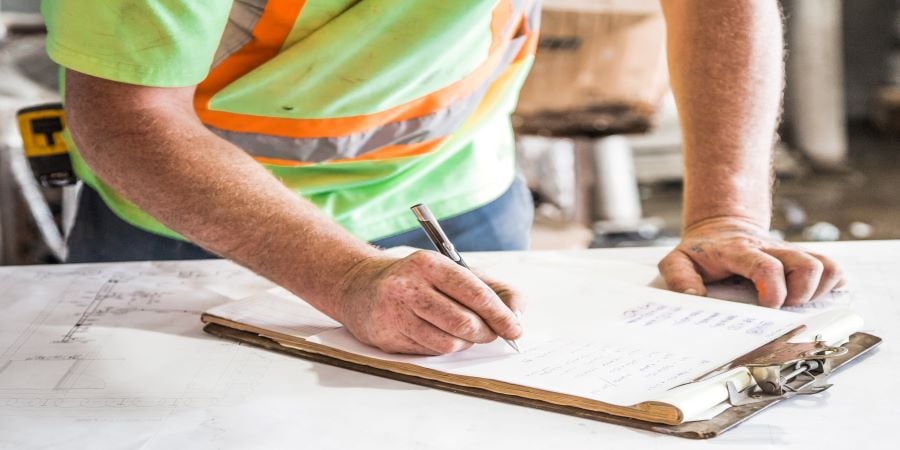 man filling out safety paperwork