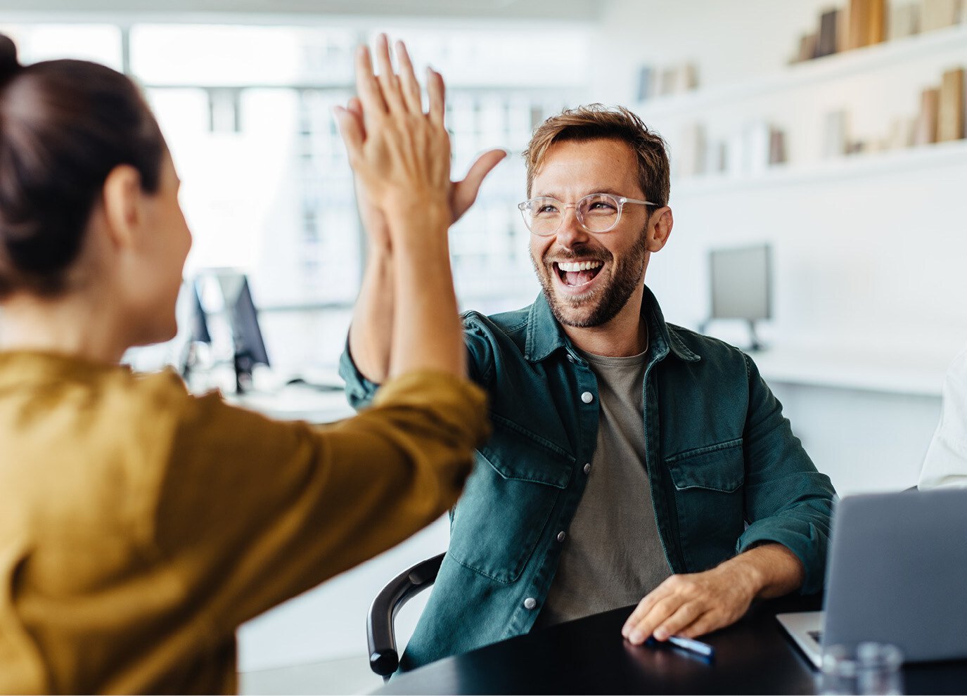 Team members giving a high-five - Hubspot